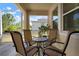 Relaxing screened patio featuring a cozy dining area with comfortable seating and view of lush greenery at 5102 Coastal Scene Dr, Apollo Beach, FL 33572