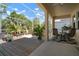 Inviting screened lanai boasts a wooden deck, seating, and dining area, offering serene outdoor living at 5102 Coastal Scene Dr, Apollo Beach, FL 33572