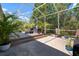 Spacious screened patio featuring a multi-level wood deck and comfortable lounge seating overlooking lush greenery at 5102 Coastal Scene Dr, Apollo Beach, FL 33572