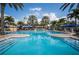 Spacious pool with a lighthouse, water slide, and surrounding palm trees, perfect for Gathering fun at 5102 Coastal Scene Dr, Apollo Beach, FL 33572