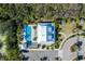 A beautiful community pool with chairs and umbrellas, surrounded by a parking lot and trees at 5102 Coastal Scene Dr, Apollo Beach, FL 33572