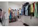 Well-organized walk-in closet with rods, shelving, and carpet, offering plenty of storage space at 5102 Coastal Scene Dr, Apollo Beach, FL 33572