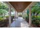 Inviting tiled walkway framed by classic columns and lush tropical landscaping at 5102 Coastal Scene Dr, Apollo Beach, FL 33572