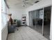 Bright enclosed balcony offering extra living space with tile flooring, ceiling fan and sliding glass doors at 5155 9Th N Ave # 206 B, St Petersburg, FL 33710