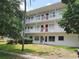 A multi-level residential building has white railings and manicured green spaces at 5155 9Th N Ave # 206 B, St Petersburg, FL 33710