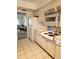 Kitchen featuring white appliances, tile flooring, and cabinetry at 5155 9Th N Ave # 206 B, St Petersburg, FL 33710
