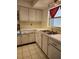 Kitchen features tile flooring, neutral cabinets, and double stainless steel sinks at 5155 9Th N Ave # 206 B, St Petersburg, FL 33710