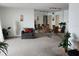 Spacious living room with a large mirrored wall, seating, and dining area with a glass table at 5155 9Th N Ave # 206 B, St Petersburg, FL 33710