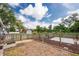 The yard features a fenced perimeter and xeriscaping; the outbuilding can be seen in the background at 5675 Lown N St, St Petersburg, FL 33714