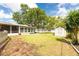 Spacious backyard featuring a shed, mature trees, and a screened-in porch at 5675 Lown N St, St Petersburg, FL 33714