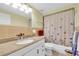 Well-lit bathroom with vanity, granite countertop, and shower-tub with butterfly curtain at 5675 Lown N St, St Petersburg, FL 33714