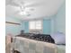 Charming bedroom featuring light blue walls, a ceiling fan, and comfortable furnishings at 5675 Lown N St, St Petersburg, FL 33714