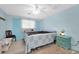 Cozy bedroom featuring light blue walls, a ceiling fan, and comfortable furnishings at 5675 Lown N St, St Petersburg, FL 33714