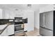 Well-maintained kitchen with stainless steel appliances, granite countertops, and white cabinets at 5675 Lown N St, St Petersburg, FL 33714