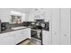 Well-maintained kitchen with stainless steel appliances, granite countertops, and white cabinets at 5675 Lown N St, St Petersburg, FL 33714