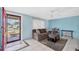 Cozy living room with neutral walls, comfortable sofa, tile floor, and ample natural light at 5675 Lown N St, St Petersburg, FL 33714
