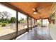 Sunroom has slate floors, ceiling fan, and views of the fenced backyard at 5675 Lown N St, St Petersburg, FL 33714