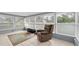 Sunroom featuring a recliner, many bright windows and tile floors at 5675 Lown N St, St Petersburg, FL 33714