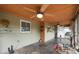 The enclosed sunroom has slate flooring, a ceiling fan, and natural light at 5675 Lown N St, St Petersburg, FL 33714