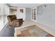 A comfortable sunroom includes a chair, patterned rug, and tiled floor at 5675 Lown N St, St Petersburg, FL 33714