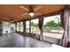 Enclosed sunroom boasting slate floors, a ceiling fan, and views of the backyard at 5675 Lown N St, St Petersburg, FL 33714