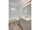 Well-lit bathroom with white tile, updated vanity, and modern fixtures at 6014 S 82Nd St, Tampa, FL 33619
