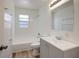Bathroom with updated vanity, mirror and shower-tub combination at 6014 S 82Nd St, Tampa, FL 33619
