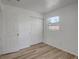 Bedroom with modern wood-look floors, closet, and natural light at 6014 S 82Nd St, Tampa, FL 33619