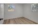 Bright bedroom with wood-look flooring and window views at 6014 S 82Nd St, Tampa, FL 33619