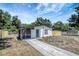 Charming single-story home with a blue door, screened porch, fresh paint, and a well-maintained front yard at 6014 S 82Nd St, Tampa, FL 33619