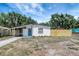 Single-story home featuring a screened porch and a freshly painted exterior with newer landscaping and a wood fence at 6014 S 82Nd St, Tampa, FL 33619