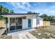 Exterior view of a home showcasing a screened porch, a freshly painted exterior, and well-maintained landscaping features at 6014 S 82Nd St, Tampa, FL 33619