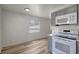 Kitchen with light countertops, white appliances and grey shaker cabinets at 6014 S 82Nd St, Tampa, FL 33619
