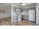Updated kitchen features grey cabinets, white appliances, and light countertops at 6014 S 82Nd St, Tampa, FL 33619