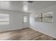 Well-lit living room featuring updated flooring, a neutral color palette, and bright windows for a modern feel at 6014 S 82Nd St, Tampa, FL 33619