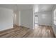 Bright living room featuring new flooring, fresh white paint, and abundant natural light from the large windows at 6014 S 82Nd St, Tampa, FL 33619