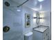 Updated bathroom with marble-patterned tiled shower, granite countertop vanity, stylish mirror and sconce lighting at 6060 Shore S Blvd # 903, Gulfport, FL 33707