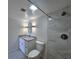 Bathroom featuring granite vanity top, modern vanity lights, ceramic tile flooring and a shower with marble-patterned tile at 6060 Shore S Blvd # 903, Gulfport, FL 33707