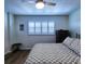 Charming bedroom with wood-look floors, shuttered window, ceiling fan and an accent cabinet at 6060 Shore S Blvd # 903, Gulfport, FL 33707