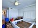Bedroom with neutral walls, ceiling fan, wood floors, and a glimpse of the ensuite bathroom at 6060 Shore S Blvd # 903, Gulfport, FL 33707