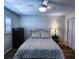 Bedroom featuring wood-look floors, a stylish bed with decorative pillows and natural light from shuttered window at 6060 Shore S Blvd # 903, Gulfport, FL 33707