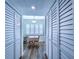 Hallway between closet spaces leading to the dining area, featuring natural light and wood floors at 6060 Shore S Blvd # 903, Gulfport, FL 33707