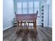 Bright dining area features wood floors and a window with shutter style blinds at 6060 Shore S Blvd # 903, Gulfport, FL 33707