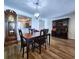 Dining room and built in desk area features a grand light fixture and hardwood floors at 6060 Shore S Blvd # 903, Gulfport, FL 33707