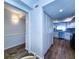 Hallway view showing wood floors and access to a kitchen with stainless appliances at 6060 Shore S Blvd # 903, Gulfport, FL 33707