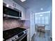 Modern kitchen featuring stainless appliances, granite counters, and white cabinets at 6060 Shore S Blvd # 903, Gulfport, FL 33707
