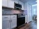 Modern kitchen with stainless steel appliances and light wood flooring at 6060 Shore S Blvd # 903, Gulfport, FL 33707