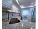 Well-lit kitchen boasts granite counters, stainless sink, and modern appliances at 6060 Shore S Blvd # 903, Gulfport, FL 33707
