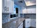 Modern kitchen featuring white cabinets, granite countertops, and stainless steel appliances at 6060 Shore S Blvd # 903, Gulfport, FL 33707