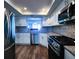 Modern kitchen featuring white cabinets, granite countertops, stainless steel appliances, and views to the water at 6060 Shore S Blvd # 903, Gulfport, FL 33707